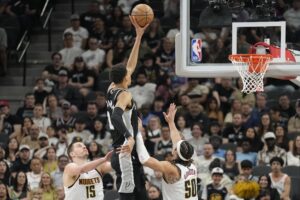 San Antonio Spurs big man Victor Wembanyama shoots over three-time MVP Nikola Jokic