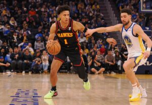 Atlanta Hawks forward Jalen Johnson takes Golden State Warriors player off the dribble