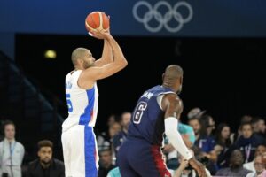 Team France forward Nic Batum shoots over Team USA forward LeBron James in Paris Olympics