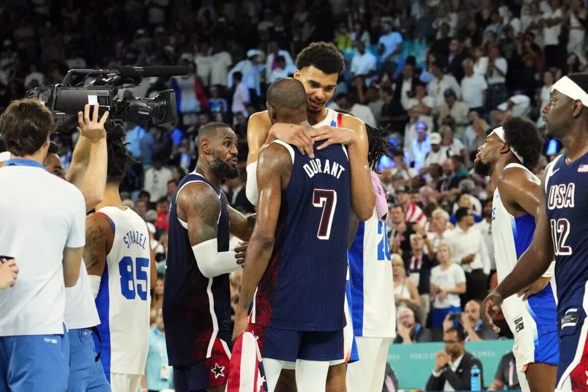 San Antonio Spurs big man Victor Wembanyama speaks to Phoenix Suns forward Kevin Durant after the Paris Olympics