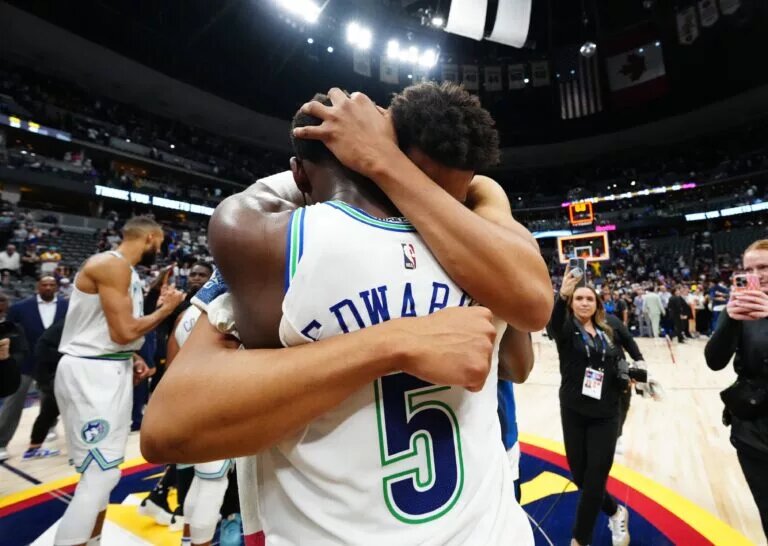 Minnesota Timberwolves center Karl-Anthony Towns (32) and guard Anthony Edwards (5) celebrate