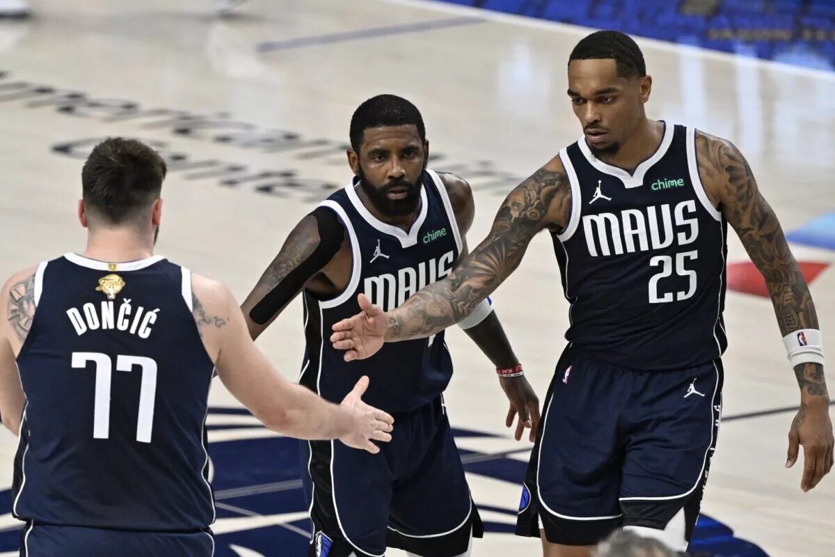 Dallas Mavericks guard Kyrie Irving (11) and forward P.J. Washington (25) celebrate with guard Luka Doncic (77)