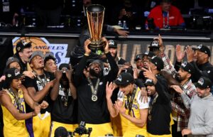 Dec 9, 2023; Las Vegas, Nevada, USA; Los Angeles Lakers forward LeBron James (23) hoists the NBA Cup and celebrates with teammates after winning the NBA In-Season Tournament Championship game against the Indiana Pacers at T-Mobile Arena. Mandatory Credit: Candice Ward-USA TODAY Sports