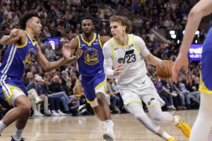 Feb 15, 2024; Salt Lake City, Utah, USA; Utah Jazz forward Lauri Markkanen (23) dribbles as Golden State Warriors forward Trayce Jackson-Davis (32) defends during the second quarter at Delta Center. Mandatory Credit: Chris Nicoll-USA TODAY Sports