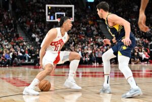 Apr 9, 2024; Toronto, Ontario, CAN; Toronto Raptors forward Jordan Nwora (13) dribbles the ball against Indiana Pacers forward Doug McDermott (20) in the first half at Scotiabank Arena. Mandatory Credit: Dan Hamilton-USA TODAY Sports