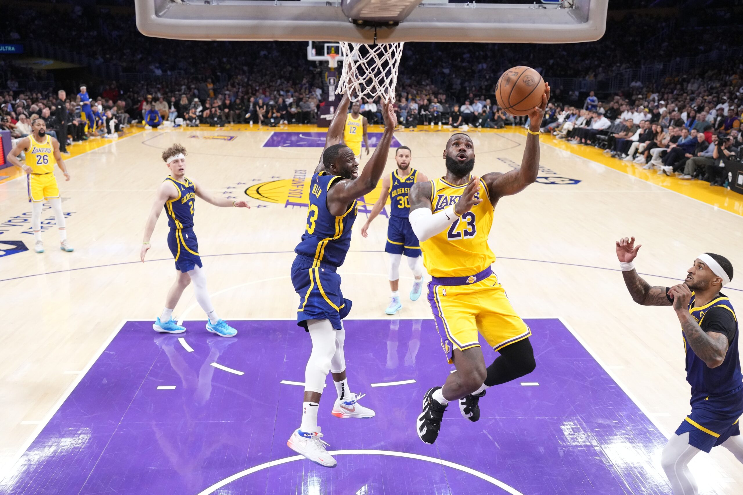 Apr 9, 2024; Los Angeles, California, USA; Los Angeles Lakers forward LeBron James (23) shoots the ball against Golden State Warriors forward Draymond Green (23) in the second half at Crypto.com Arena. Mandatory Credit: Kirby Lee-USA TODAY Sports