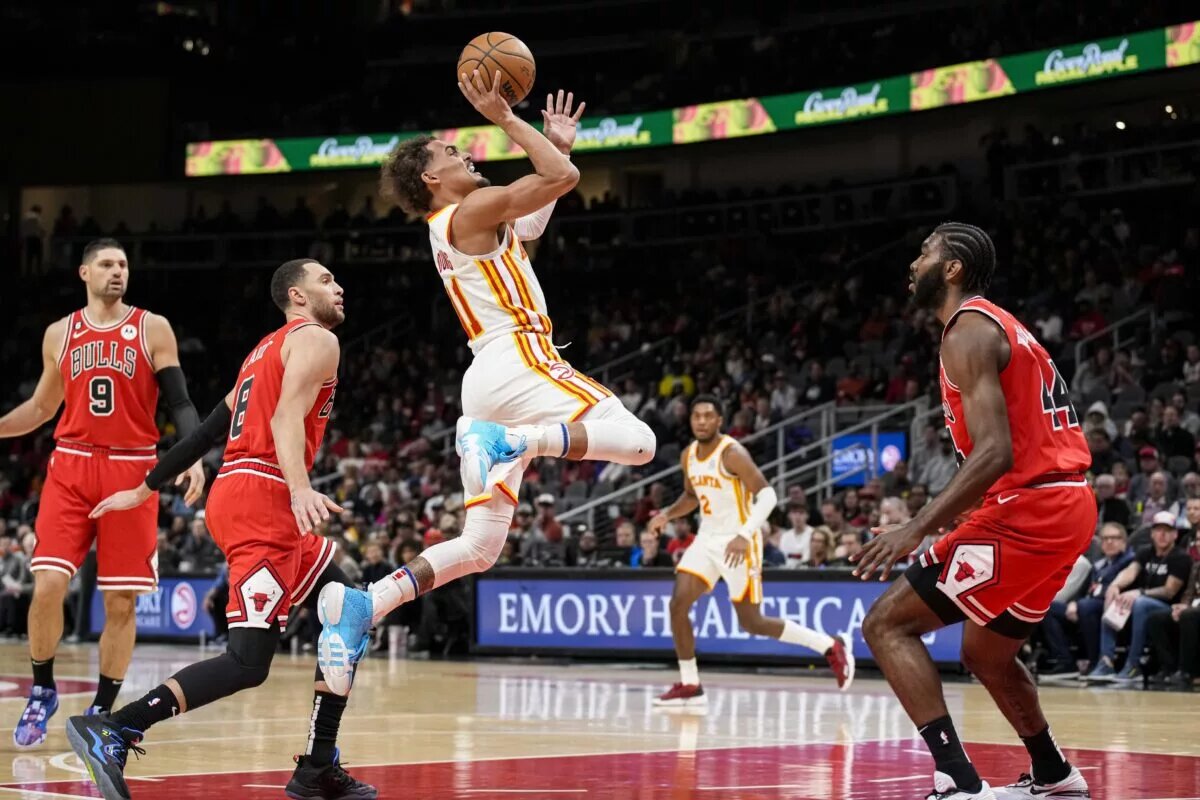 Atlanta Hawks guard Trae Young (11) shoots the ball after getting past Chicago Bulls guard Zach LaVine (8)