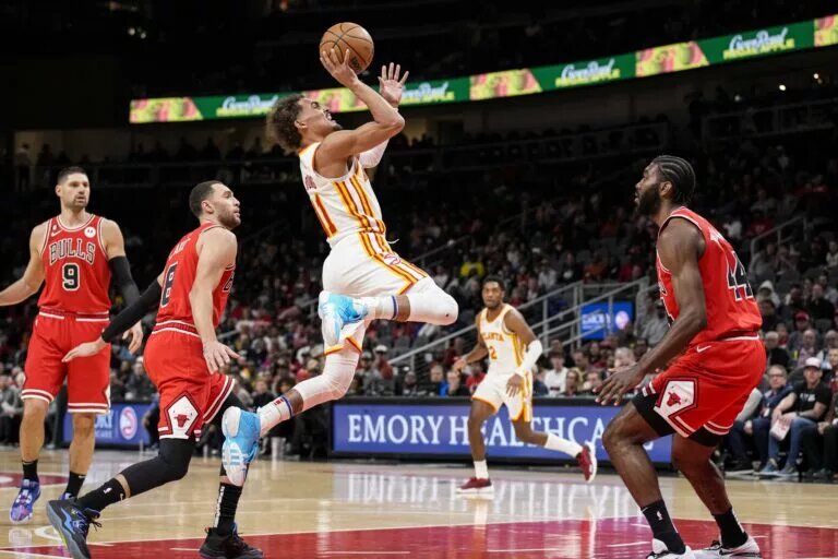 Atlanta Hawks guard Trae Young (11) shoots the ball after getting past Chicago Bulls guard Zach LaVine (8)