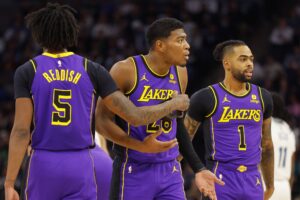 Los Angeles Lakers forward Rui Hachimura (28) reacts to his technical foul as he stands between forward Cam Reddish (5) and guard D'Angelo Russell (1)