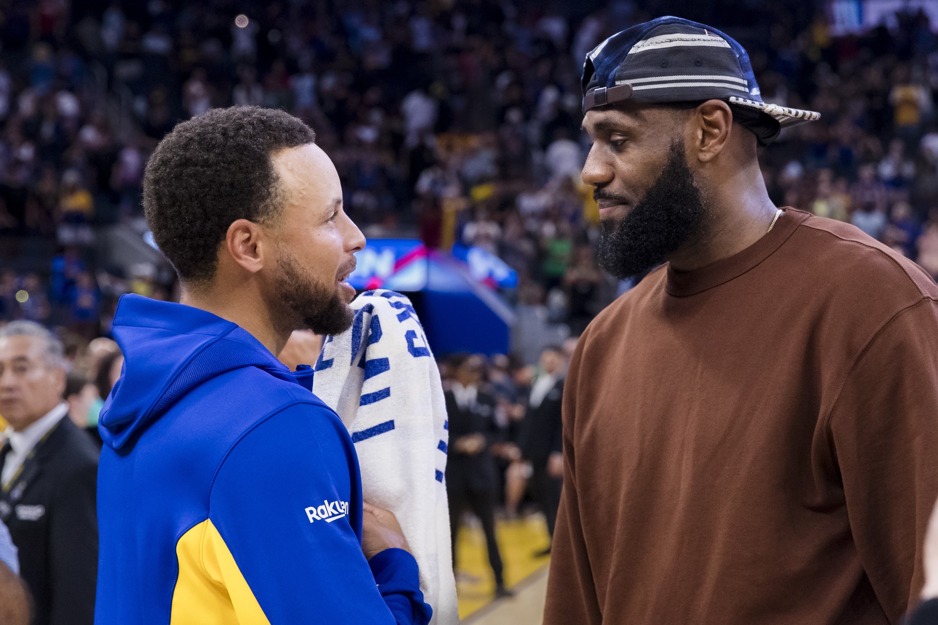 Golden State Warriors guard Stephen Curry (30) talks to Los Angeles Lakers forward LeBron James (23)