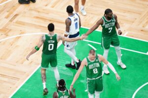 Dallas Mavericks guard Kyrie Irving surrounded by Boston Celtics players during 2024 NBA Finals