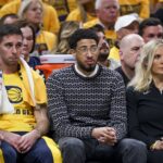 Indiana Pacers point guard Tyrese Haliburton surrounded by teammates on bench