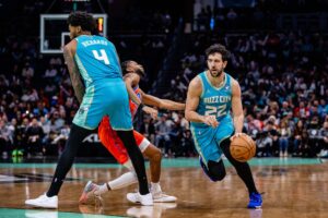 Charlotte Hornets guard Vasilije Micic (22) uses a screen from center Nick Richards (4) to separate from Oklahoma City Thunder guard Isaiah Joe (11)