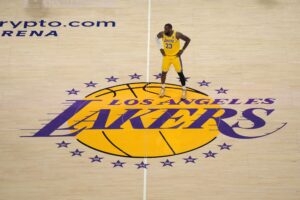 Los Angeles Lakers forward LeBron James (23) stands on the Lakers logo at center court