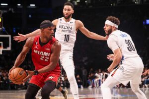 Miami Heat forward Jimmy Butler (22) looks to pass as Brooklyn Nets guard Ben Simmons (10) defends