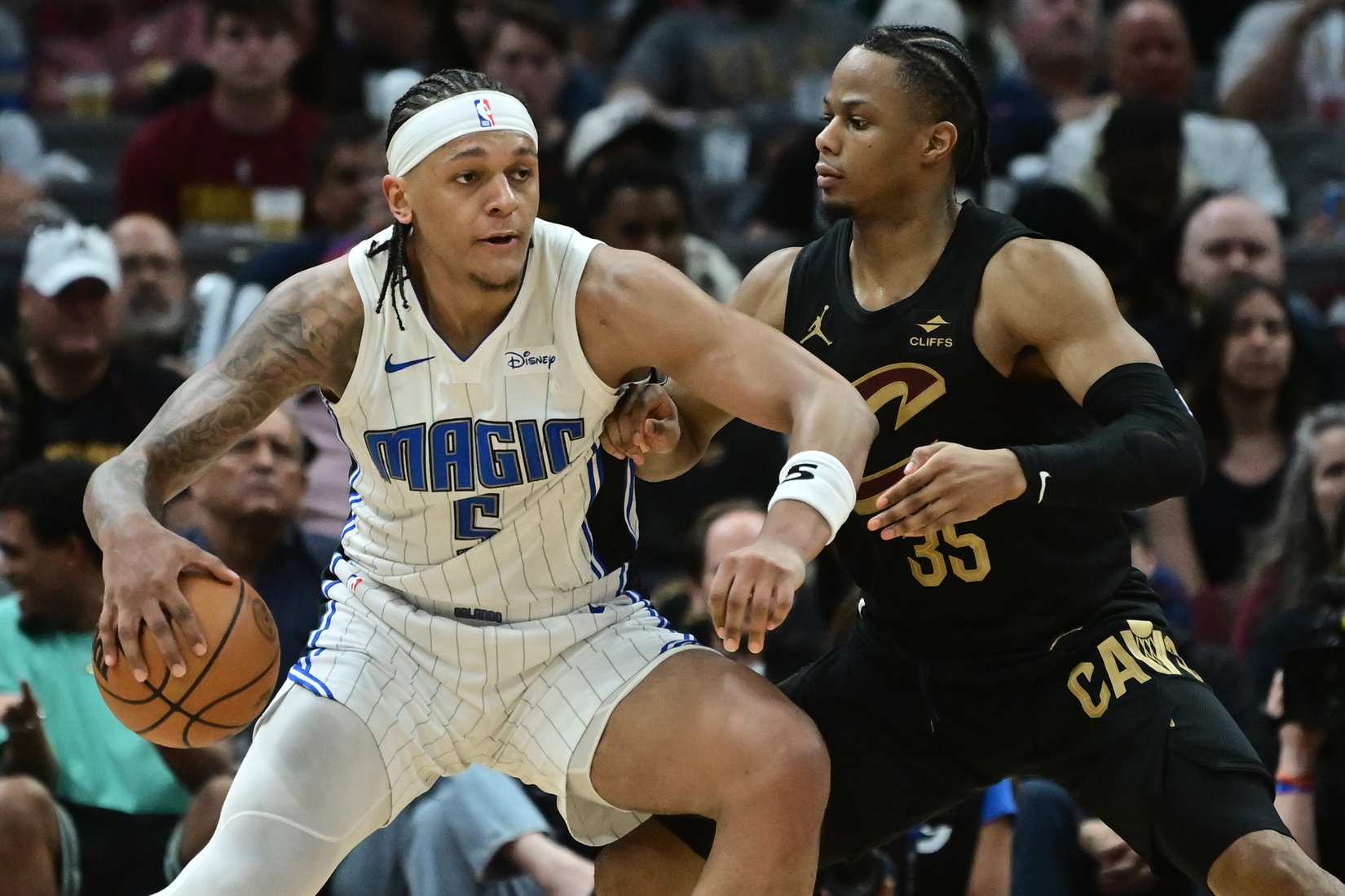 Cleveland Cavaliers forward Isaac Okoro (35) defends Orlando Magic forward Paolo Banchero (5) during the second half in game five of the first round for the 2024 NBA playoffs