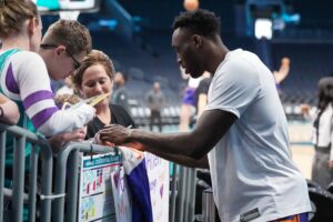 Current NBA free agent signs autographs