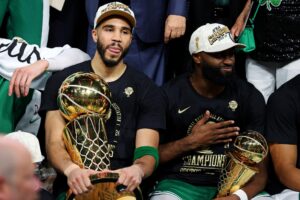 Boston Celtics forward Jayson Tatum (0) and guard Jaylen Brown (7) celebrates with the Larry O’Brien Trophy