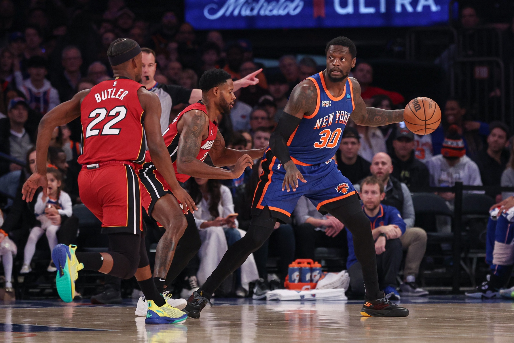 New York Knicks forward Julius Randle (30) controls the ball as Miami Heat forward Haywood Highsmith (24) and forward Jimmy Butler (22) defend