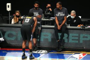 Brooklyn Nets point guard Kyrie Irving (C) and power forward Kevin Durant (R) talk to shooting guard James Harden (13) before checking into the game during the fourth quarter against the Los Angeles Clippers at Barclays Center.