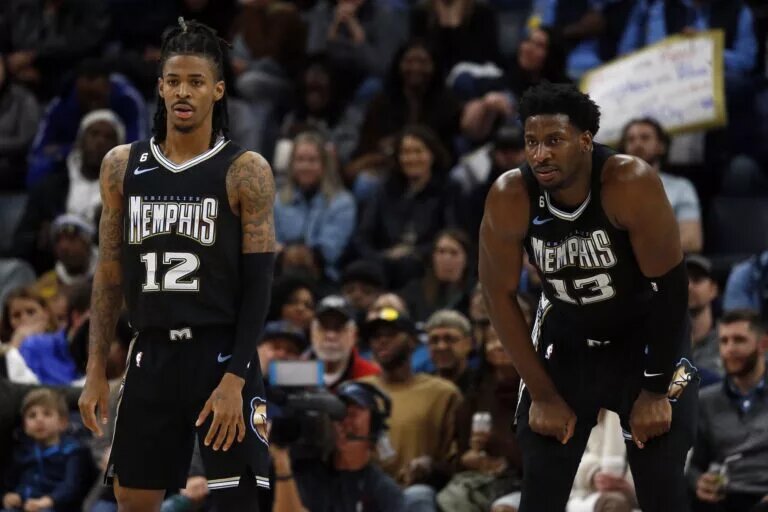 Memphis Grizzlies guard Ja Morant (12) and forward Jaren Jackson Jr. (13) wait for play to resume during the second half against the Oklahoma City Thunder at FedExForum.