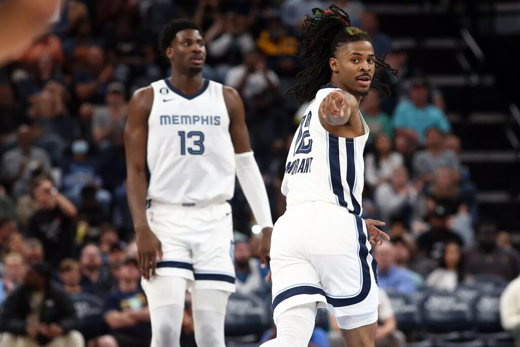Memphis Grizzlies guard Ja Morant (12) points toward Memphis Grizzlies guard Desmond Bane (not pictured) after an assist during the second half against the Portland Trail Blazers at FedExForum.