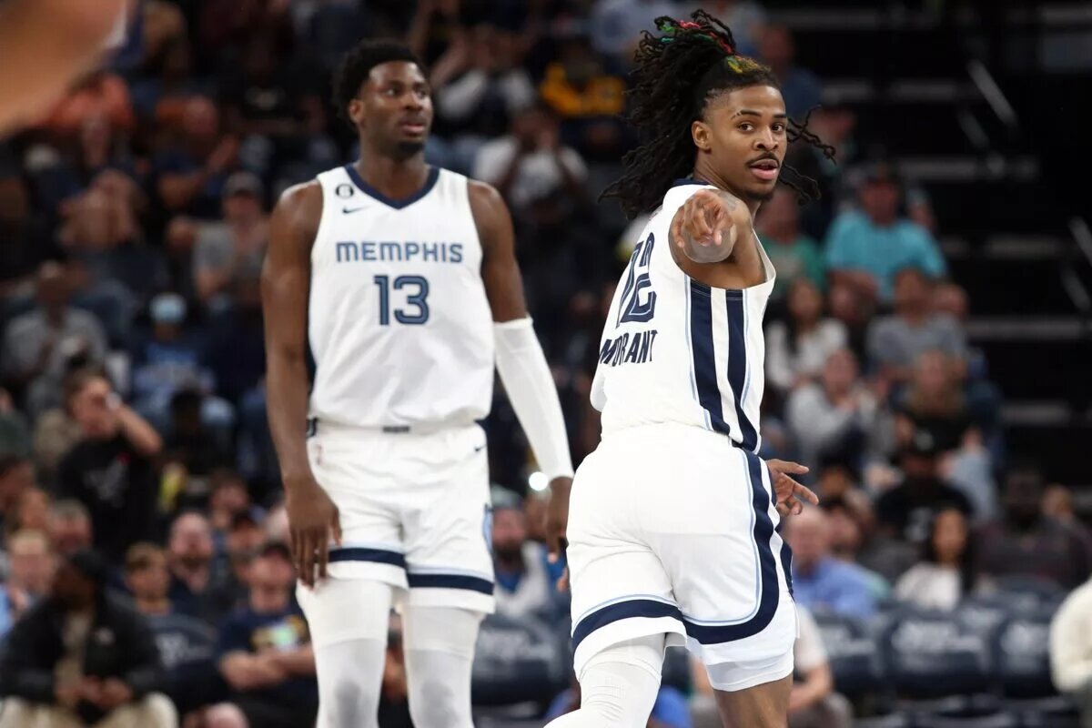 Memphis Grizzlies guard Ja Morant (12) points toward Memphis Grizzlies guard Desmond Bane (not pictured) after an assist during the second half against the Portland Trail Blazers at FedExForum.