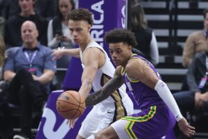 New Orleans Pelicans guard Dyson Daniels (11) and Utah Jazz guard Keyonte George (3) play for a loose ball in the first quarter at Delta Center.