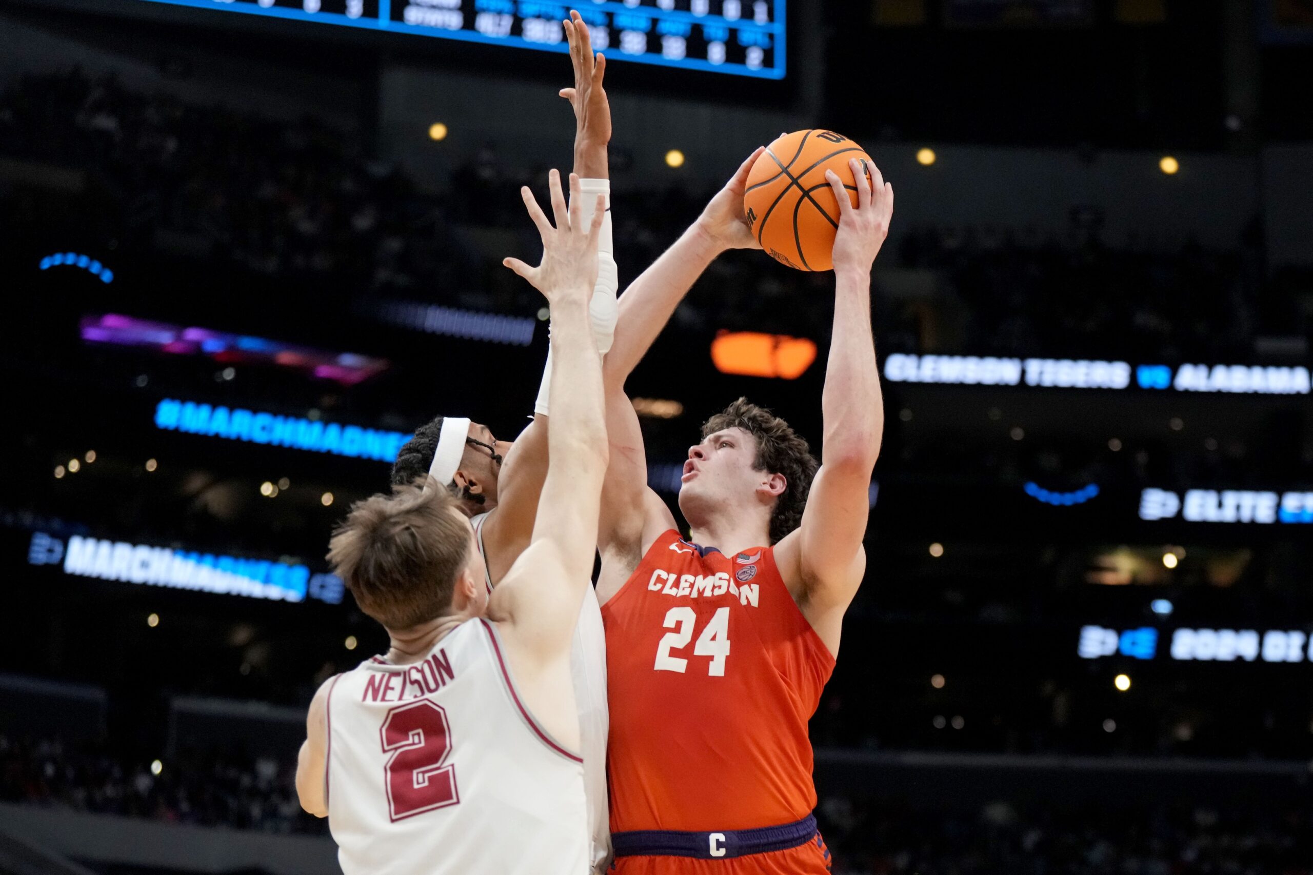 Mar 30, 2024; Los Angeles, CA, USA; Clemson Tigers center PJ Hall (24) shoots against Alabama Crimson Tide forward Jarin Stevenson (15) and forward Grant Nelson (2) in the second half in the finals of the West Regional of the 2024 NCAA Tournament at Crypto.com Arena. Mandatory Credit: Kirby Lee-USA TODAY Sports