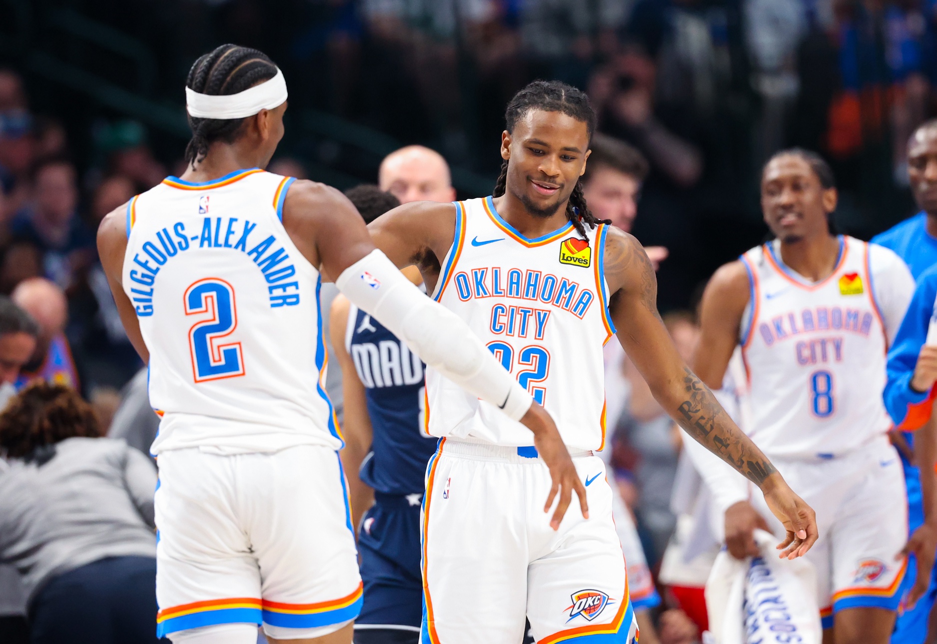 Oklahoma City Thunder guard Cason Wallace (22) celebrates with Oklahoma City Thunder guard Shai Gilgeous-Alexander (2) after scoring during the first half against the Dallas Mavericks during game three of the second round for the 2024 NBA playoffs at American Airlines Center.