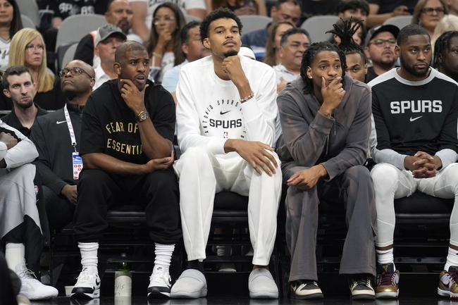 Oct 7, 2024; San Antonio, Texas, USA; San Antonio Spurs center Victor Wembanyama (1) along with guards Chris Paul (3) and Devin Vassell (24) sit out the preseason game against the Oklahoma City Thunder at Frost Bank Center. Mandatory Credit: Scott Wachter-Imagn Images