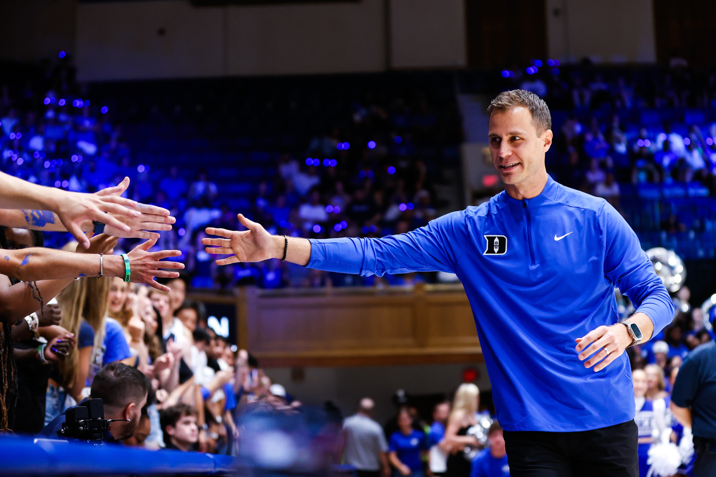 Duke Blue Devils head coach Jon Scheyer reaches for the fans