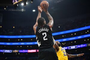 Los Angeles Clippers forward Kawhi Leonard (2) shoots against Los Angeles Lakers forward LeBron James (23)