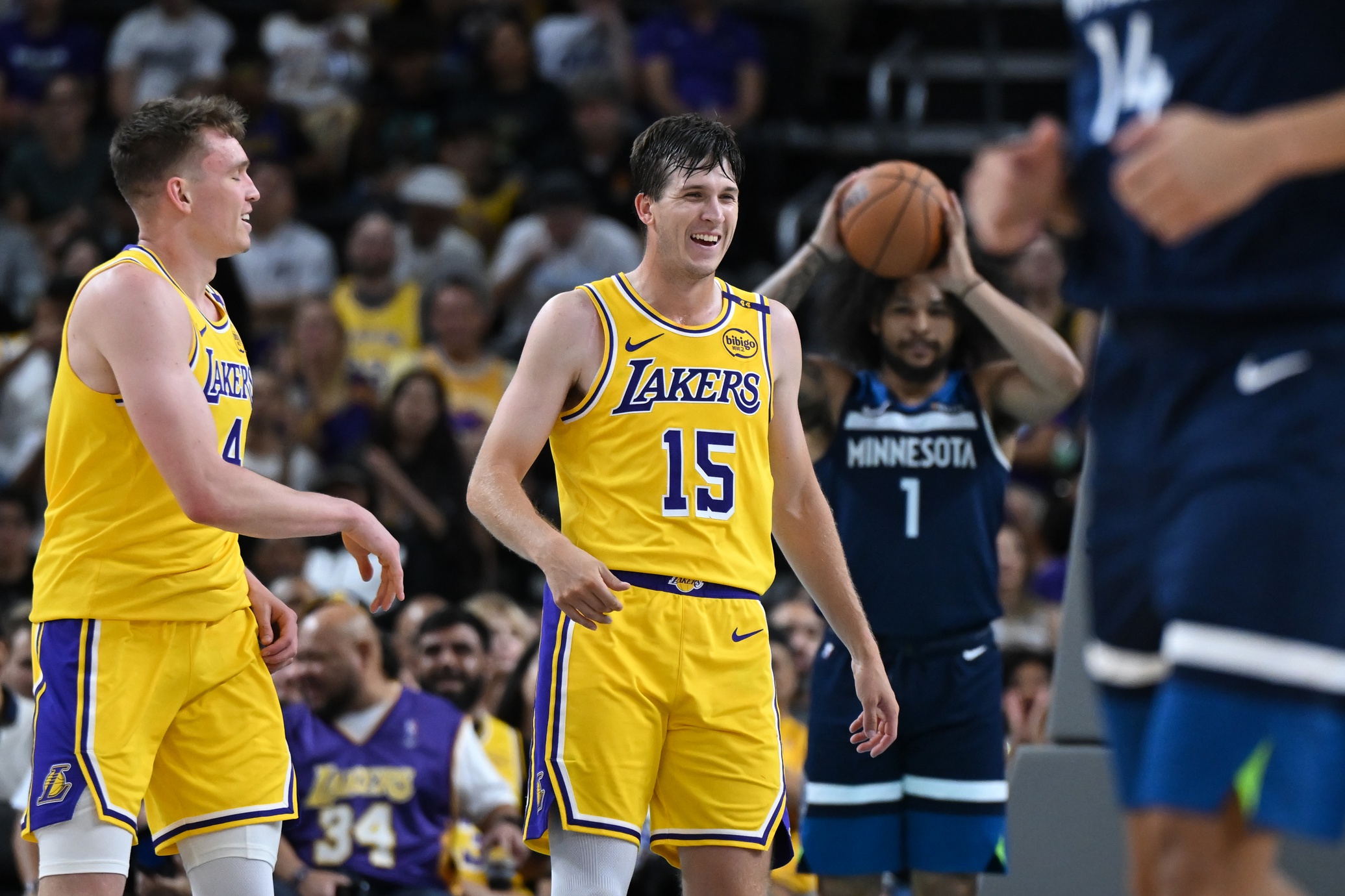 Los Angeles Lakers guard Austin Reaves (15) reacts with guard Dalton Knecht (4) after scoring