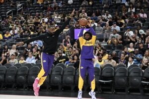 Los Angeles Lakers forward LeBron James (23) warms up with guard Bronny James (9) before the game