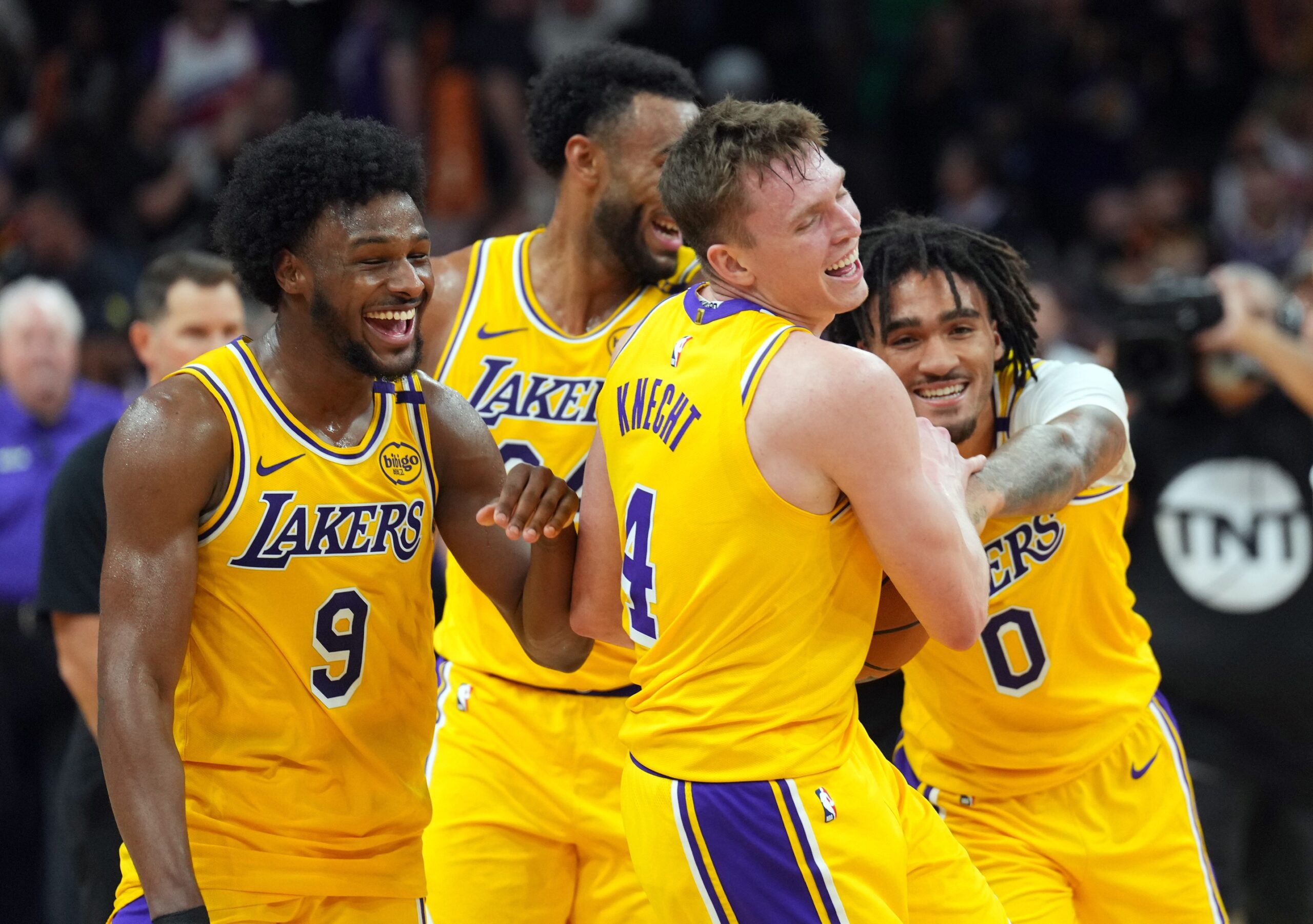 Los Angeles Lakers guard Bronny James (9) and Los Angeles Lakers guard Dalton Knecht (4) and Los Angeles Lakers guard Jalen Hood-Schifino (0) celebrate after defeating the Phoenix Suns