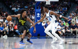 Jazz guard Collin Sexton (2) dribbles as Dallas Mavericks guard Jazian Gortman (00) defends