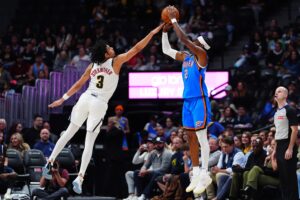 Denver Nuggets guard Julian Strawther (3) defends