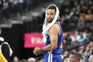 Golden State Warriors guard Stephen Curry (30) looks on from the bench