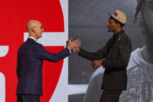 Ron Holland II shakes hands with NBA commissioner Adam Silver after being selected in the first round by the Detroit Pistons in the 2024 NBA Draft