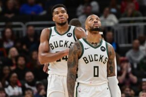 Milwaukee Bucks forward Giannis Antetokounmpo (34) and guard Damian Lillard (0) look on