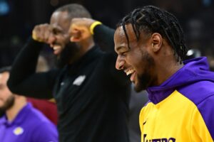 Los Angeles Lakers guard Bronny James, right, and forward LeBron James warm up before the game between the Cleveland Cavaliers