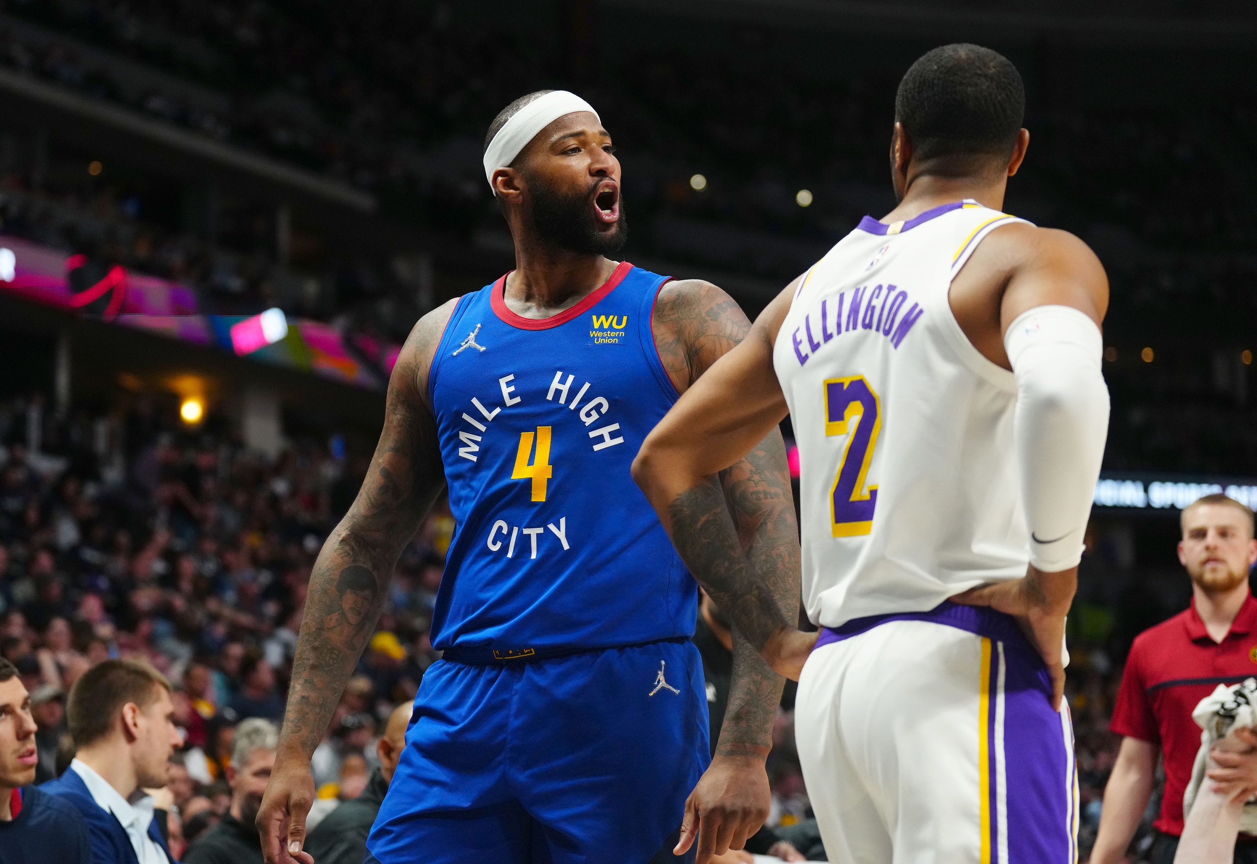 Apr 10, 2022; Denver, Colorado, USA; Denver Nuggets center DeMarcus Cousins (4) reacts in the second half against Los Angeles Lakers guard Wayne Ellington (2) in the second half at Ball Arena. Mandatory Credit: Ron Chenoy-USA TODAY Sports Bronny James