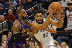 Dec 30, 2023; Minneapolis, Minnesota, USA; Minnesota Timberwolves forward Karl-Anthony Towns (32) works past Los Angeles Lakers forward LeBron James (23) in the fourth quarter at Target Center. Mandatory Credit: Bruce Kluckhohn-USA TODAY Sports