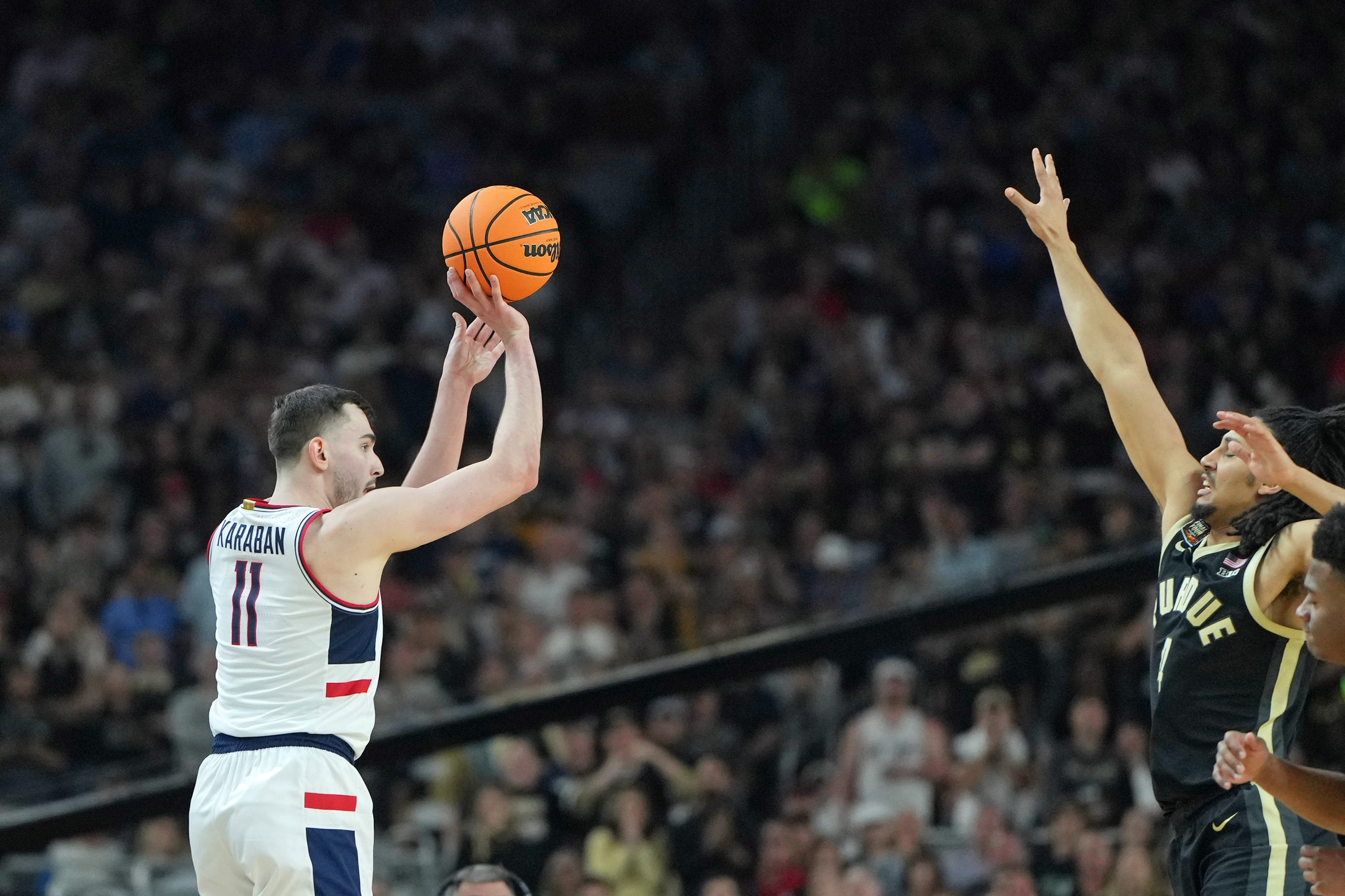 Apr 8, 2024; Glendale, AZ, USA; Connecticut Huskies forward Alex Karaban (11) shoots the ball against the Purdue Boilermakers during the second half of the national championship game of the Final Four of the 2024 NCAA Tournament at State Farm Stadium. Mandatory Credit: Bob Donnan-USA TODAY Sports