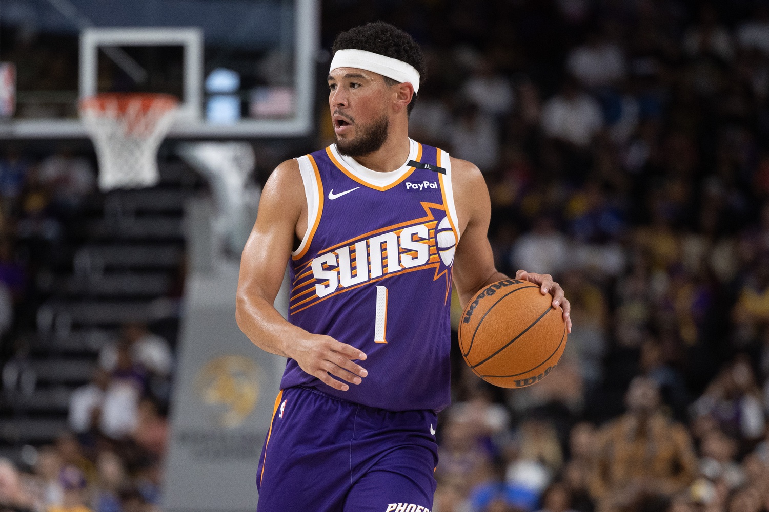 Phoenix Suns guard Devin Booker (1) moves the ball against the Los Angeles Lakers during the first half at Acrisure Arena.