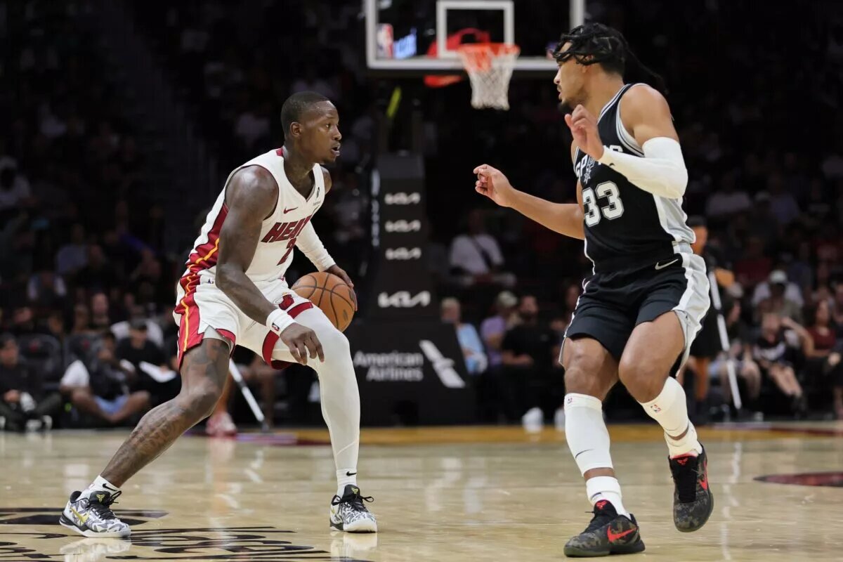 Oct 15, 2024; Miami, Florida, USA; Miami Heat guard Terry Rozier (2) dribbles the basketball as San Antonio Spurs guard Tre Jones (33) defends during the third quarter at Kaseya Center. Mandatory Credit: Sam Navarro-Imagn Images