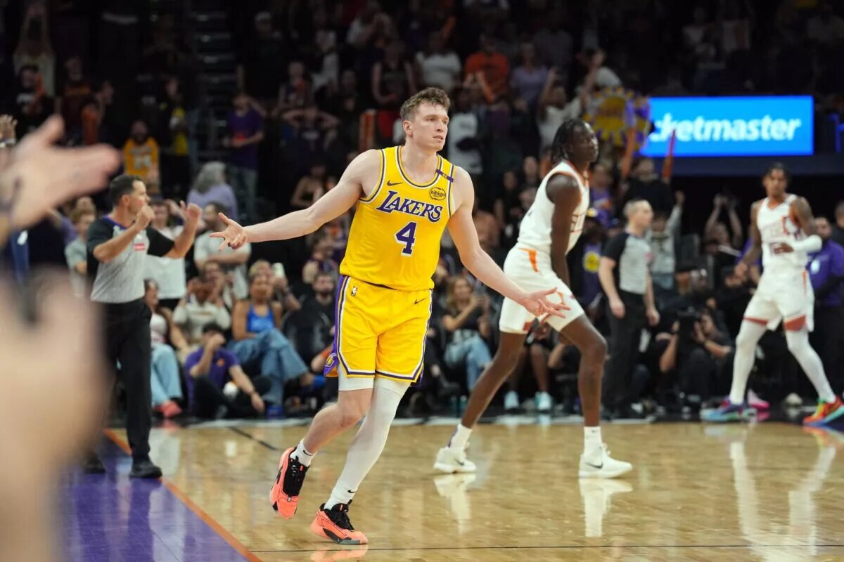 Oct 17, 2024; Phoenix, Arizona, USA; Los Angeles Lakers guard Dalton Knecht (4) reacts after making a three point basket against the Phoenix Suns during the overtime period at Footprint Center. Mandatory Credit: Joe Camporeale-Imagn Images