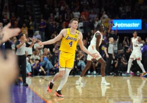 Oct 17, 2024; Phoenix, Arizona, USA; Los Angeles Lakers guard Dalton Knecht (4) reacts after making a three point basket against the Phoenix Suns during the overtime period at Footprint Center. Mandatory Credit: Joe Camporeale-Imagn Images