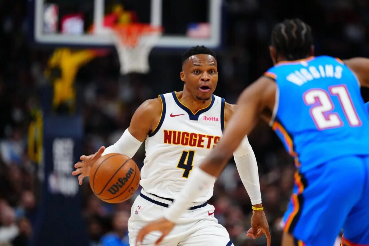 Oct 24, 2024; Denver, Colorado, USA; Denver Nuggets guard Russell Westbrook (4) drives at Oklahoma City Thunder guard Aaron Wiggins (21) in the second half at Ball Arena. Mandatory Credit: Ron Chenoy-Imagn Images